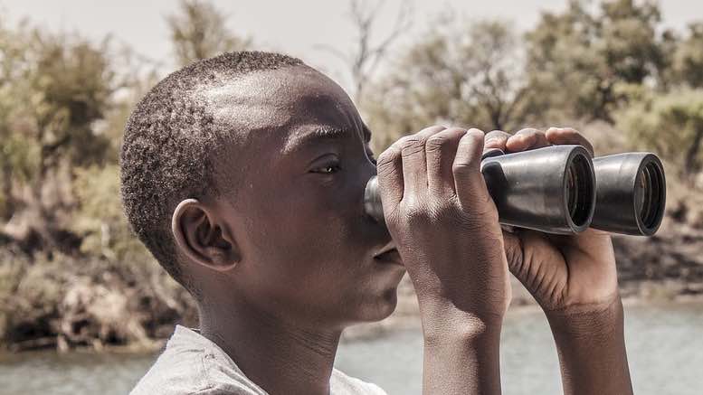 african-black-man-binoculars-monitor-watch