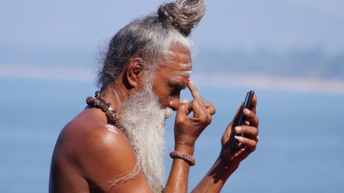 Indian-man-yogi-phone