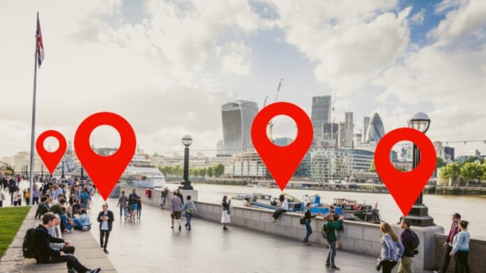 location-phone-surveillance-crowd-walking-London-South-Bank-UK